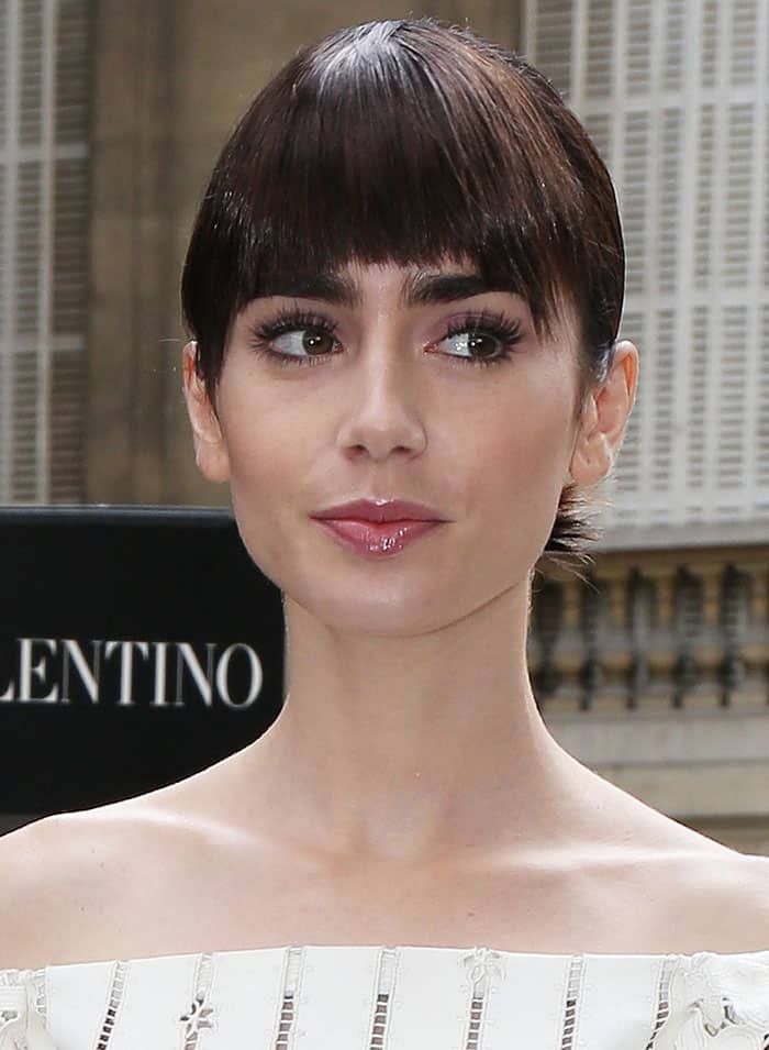 Lily Collins pulled her hair back into a chic updo with a fringe cut just right above her signature eyebrows