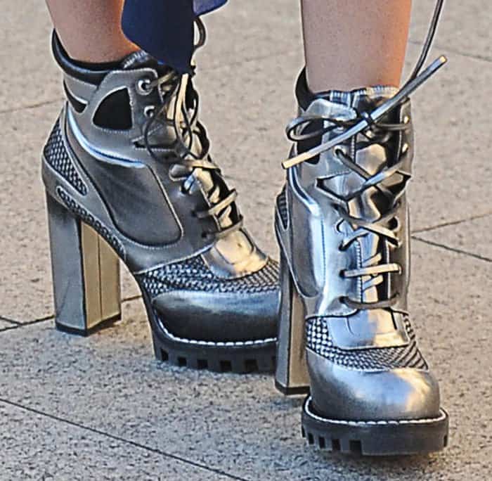 Miranda Kerr's futuristic silver leather boots are distinguished by their lace-up fastenings, roughly 0.5-inch lugged platforms, and 3.7-inch robust heels