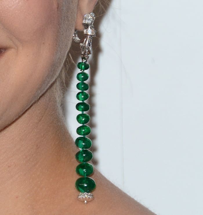 Natalie Portman's earrings feature a stunning vertical arrangement of polished emerald beads, elegantly suspended from a diamond-encrusted clasp by Van Cleef  Arpels