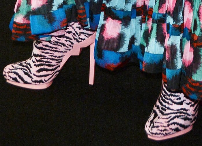 Rosario Dawson wears a quirky pair of tiger print boots from the Kenzo x HM collaboration line