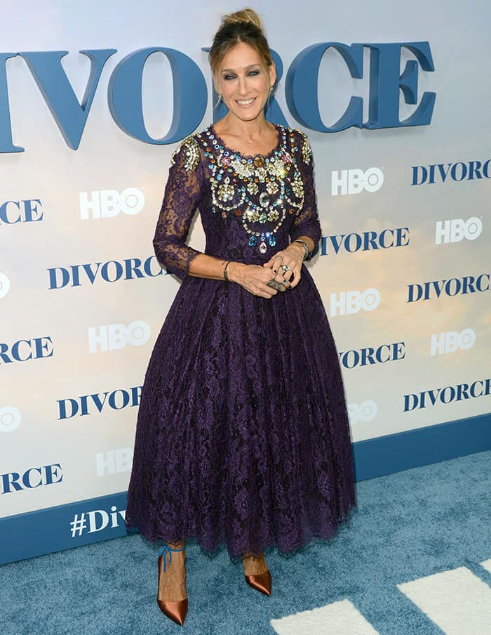 Sarah Jessica Parker accessorizing her purple Dolce Gabbana dress with bracelets rings and earrings