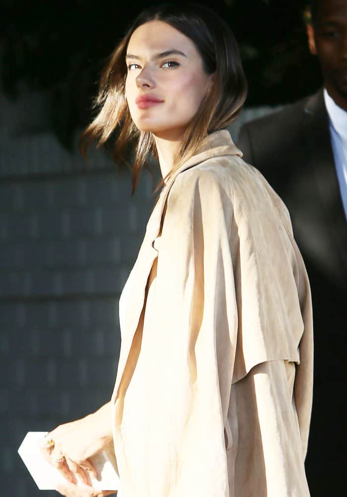 Alessandra Ambrosio exudes effortless sophistication in a draped suede trench coat