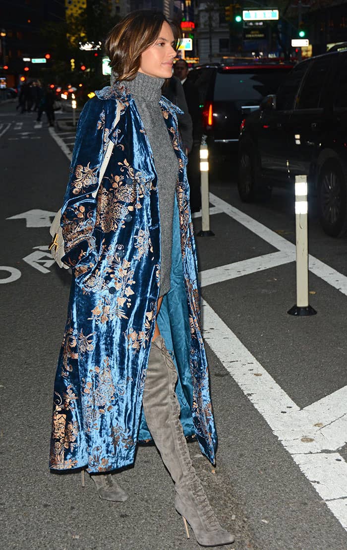 Alessandra Ambrosio turns heads in New York City, pairing a luxurious blue velvet Ralph Lauren coat with thigh-high gray suede boots for an effortlessly chic street style
