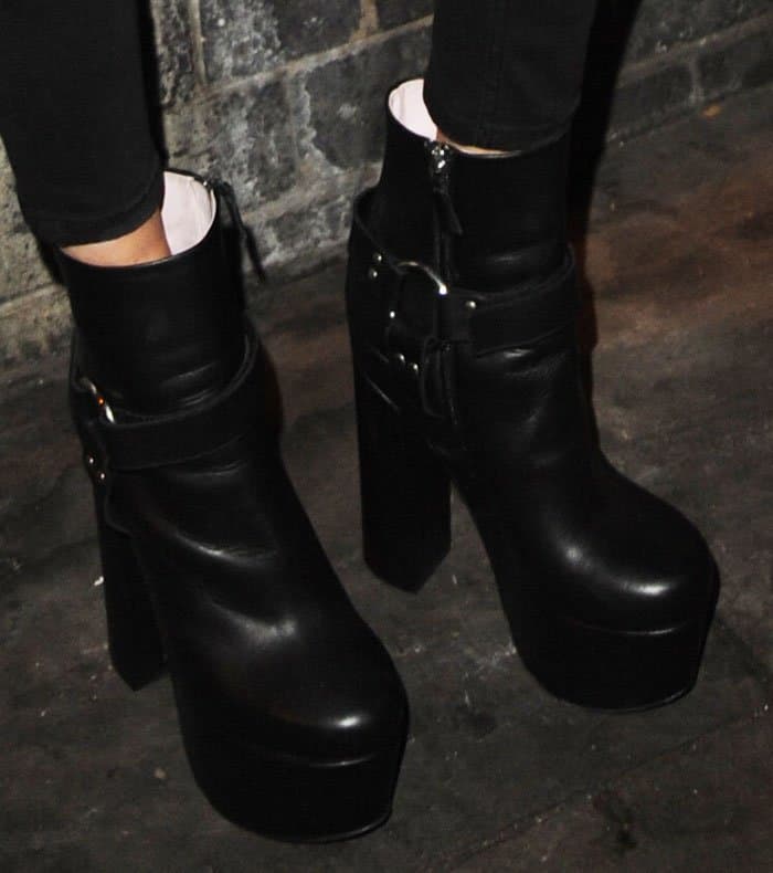 Cara Delevingne's edgy platform boots feature harness straps, metal rings, and towering block heels