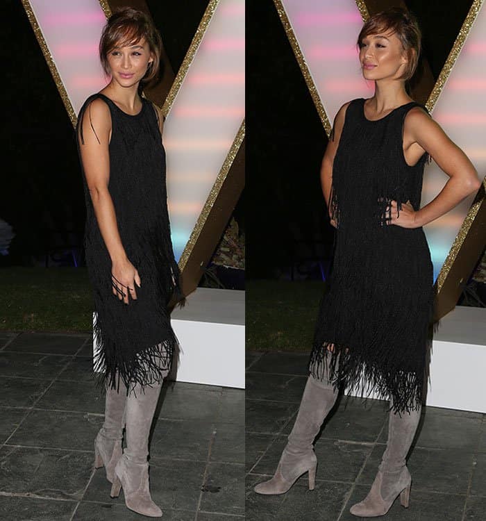 Cara Santana's look is polished yet effortless, with a chic messy bun and soft, natural makeup completing her ensemble