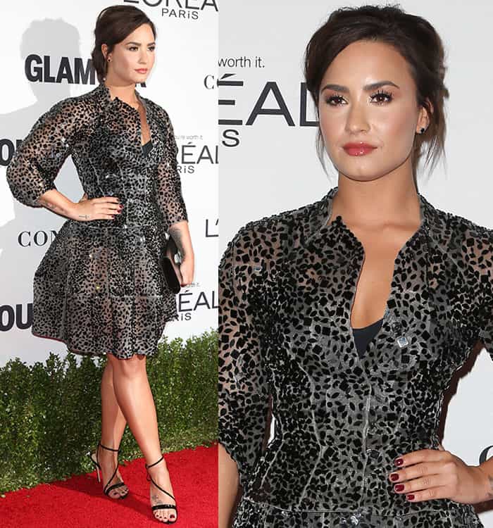Demi Lovato complements her look with a voluminous updo, bold smoky eyes, and glossy nude lips