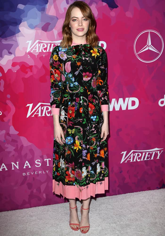 Emma Stone brought a burst of color to Variety and WWD’s 2nd StyleMakers Awards in a vibrant floral Gucci dress paired with salmon-pink Jimmy Choo ‘Minny’ sandals that subtly echoed the dress’s pastel trim