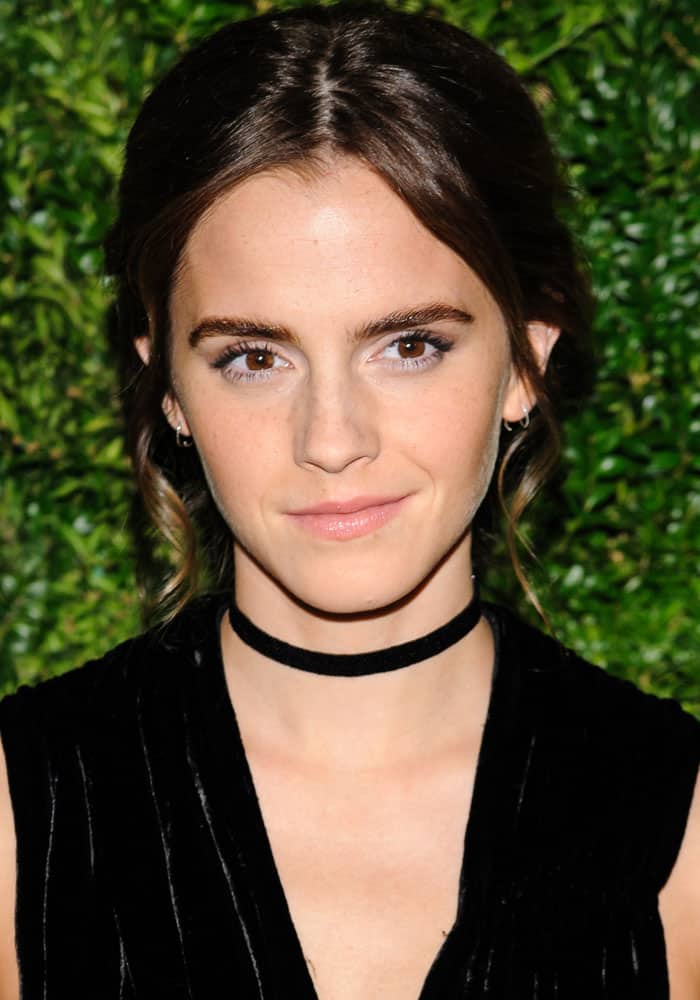 Emma Watson complemented her velvet dress with a sleek updo and soft, natural makeup that highlighted her radiant complexion