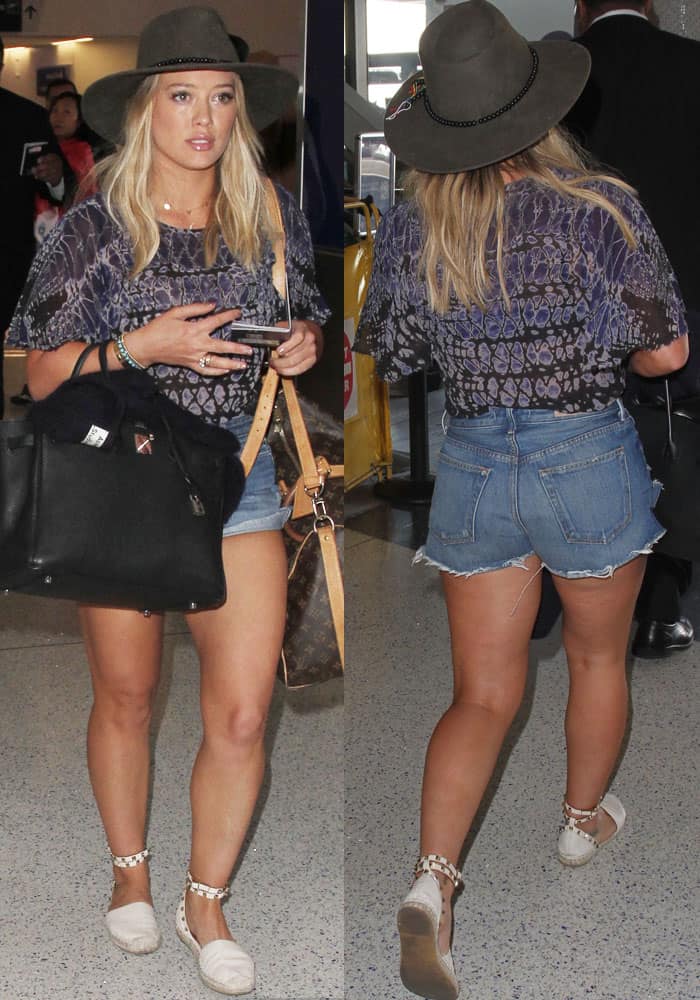 Hilary Duff shows off her toned legs in denim cutoffs paired with Valentino 'Rockstud' espadrilles and a loose patterned top