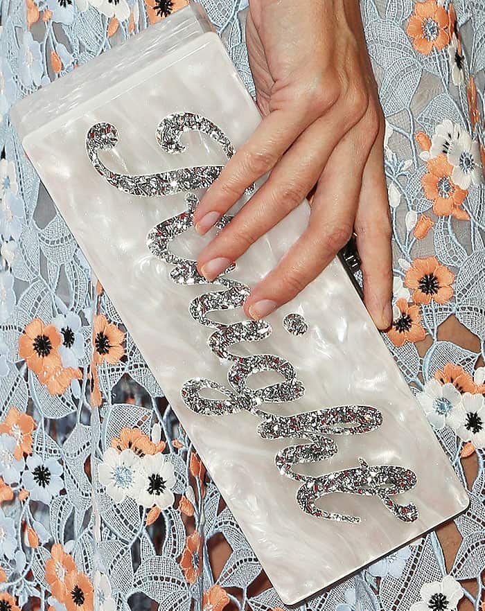 Jaime King accessorizes her look with a personalized Edie Parker "Flavia" clutch featuring her son's name, Knight, in a glittering script