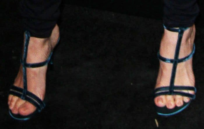 January Jones showed off her feet in sleek Tom Ford velvet T-strap sandals, featuring bold straps and a sculptural silhouette that echoed the brand’s signature mix of sensuality and precision tailoring