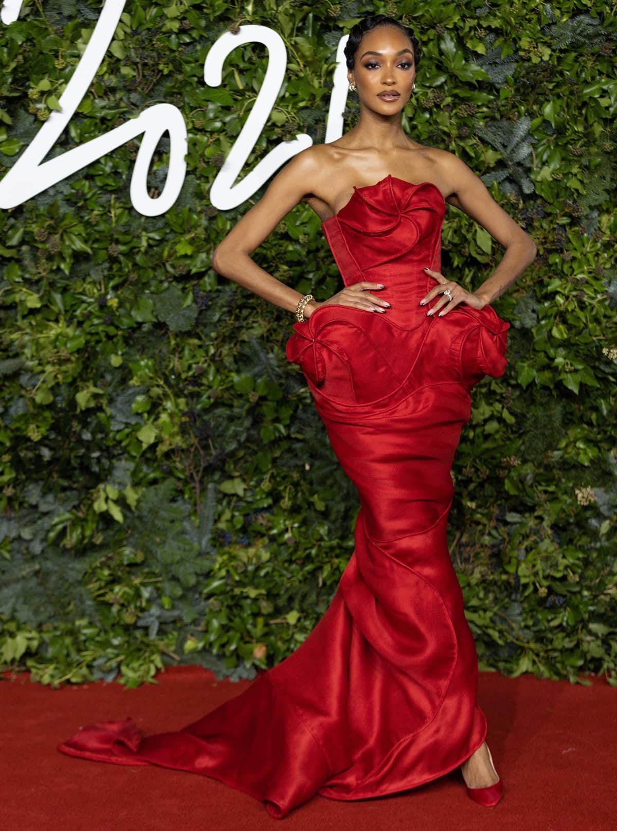 Jourdan Dunn wears Andrea Brocca’s sculptural red Midnight Gown with tonal Christian Louboutin pumps at The Fashion Awards 2021 at London’s Royal Albert Hall