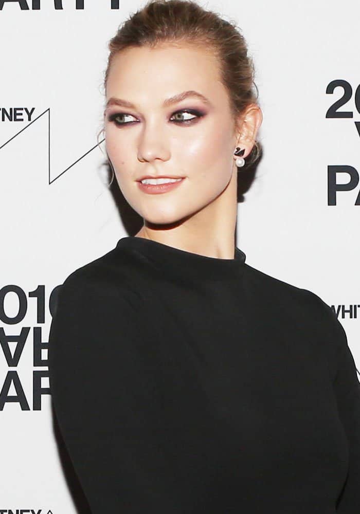 Karlie Kloss stuns with a sleek updo that perfectly showcases her bold Swarovski 'Swan' earrings