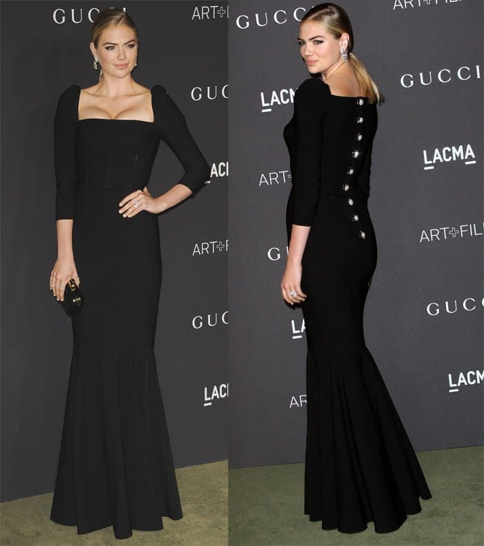 Kate Upton looked stunning in a black long-sleeved Dolce Gabbana dress with a pleated hem and distinctive square neckline