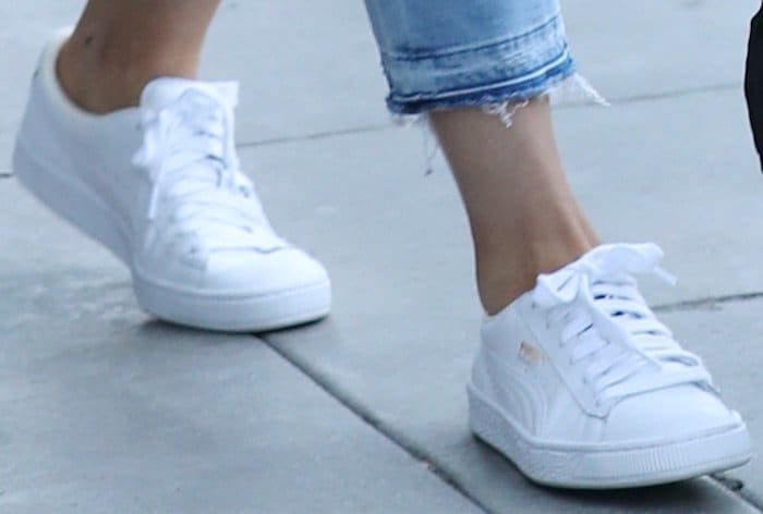 Kylie Jenner completes her casual look with a pair of classic white Puma Basket sneakers