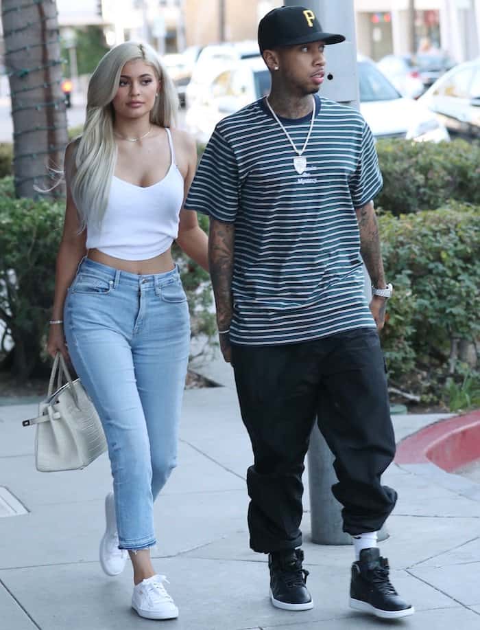 Kylie Jenner heads to Escala in Los Angeles for lunch with boyfriend Tyga in Good American jeans, a crop top, and Puma Basket Classic sneakers