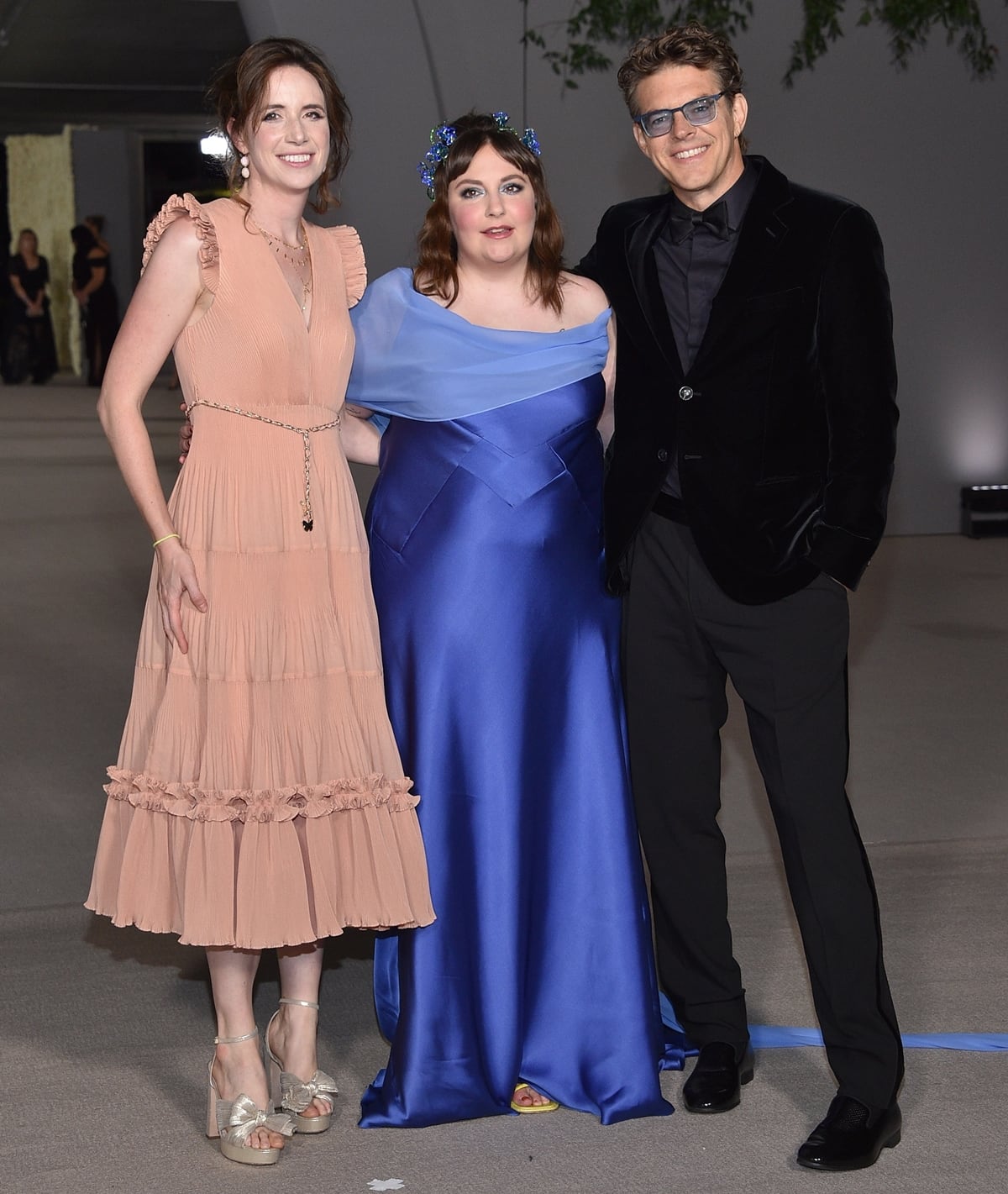 Lauren A. E. Schuker, Lena Dunham in yellow peep-toe heels and a cobalt satin gown, and Jason Blum attend the 2nd Annual Academy Museum Gala on October 15, 2022, in Los Angeles
