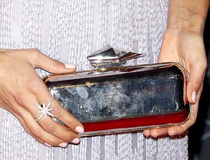 Nina Dobrev paired her mirrored Jimmy Choo Cloud Tube clutch with a dazzling starburst ring