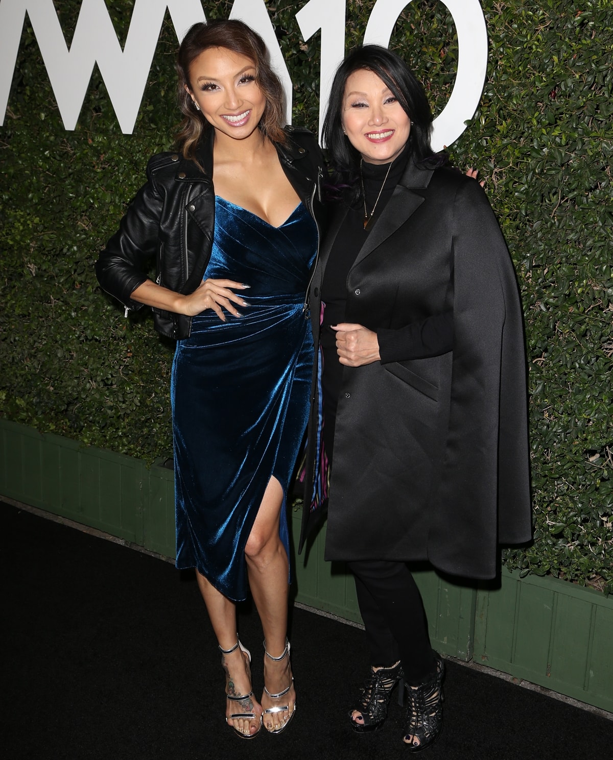 Jeannie Camtu Mai poses with her Vietnamese mother, Olivia Tu Tram Duong, who looked elegant in a black cape coat and lace-up peep-toe booties