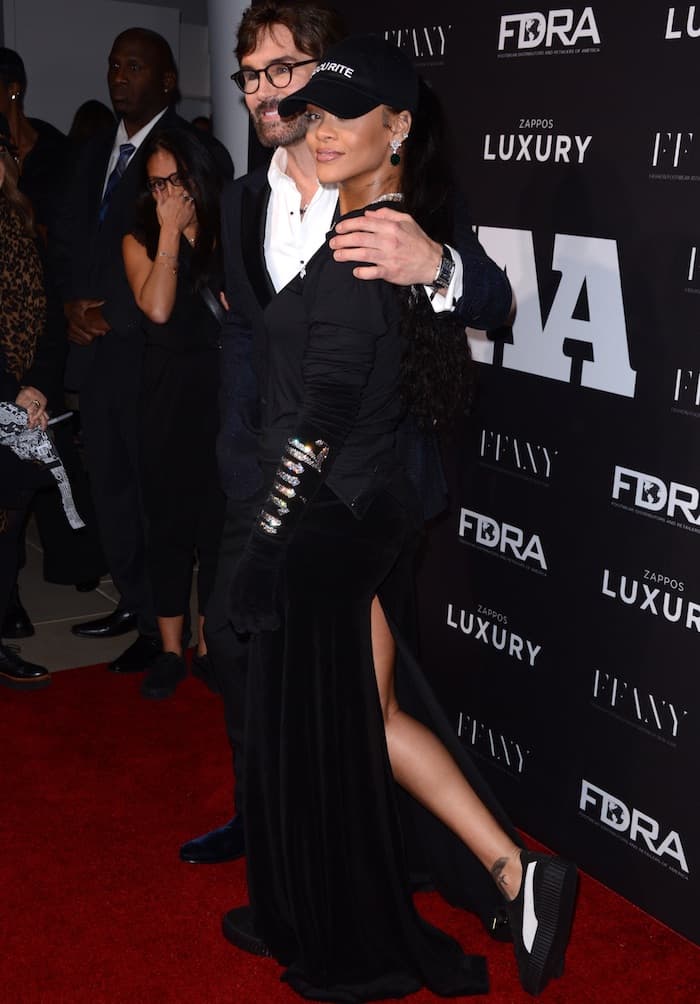 Rihanna in a velvet maxi skirt and long-sleeved shirt at the Footwear News Achievement Awards