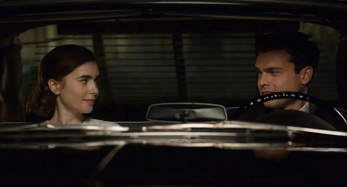Lily Collins and Alden Ehrenreich share an intimate moment in Rules Don't Apply, capturing the film’s 1950s Hollywood romance vibe