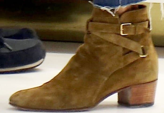 Alessandra Ambrosio completes her casual-chic ensemble with Saint Laurent's tan suede “Blake” ankle boots, featuring wraparound buckle straps and a stacked wooden heel