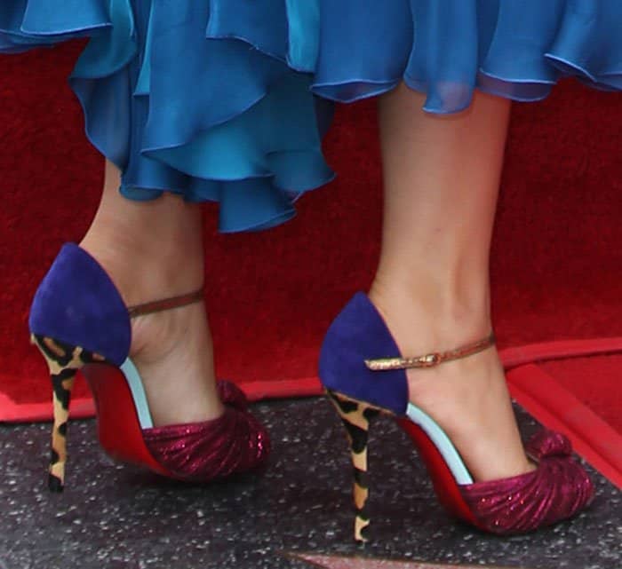 Blake Lively stuns in her Christian Louboutin "Marchavekel" heels, showcasing a striking combination of rich purple and blue hues with glittering knotted detailing on the toes and leopard-print heels, complete with the signature red sole