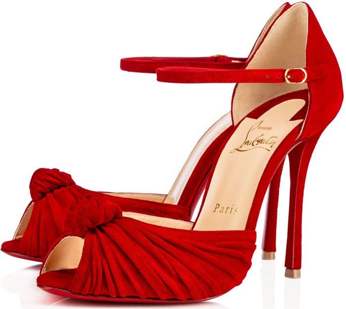 A vivid red suede version of the Christian Louboutin Marchavekel highlights the shoe’s signature turban-knot vamp and dramatic platform-stiletto proportions
