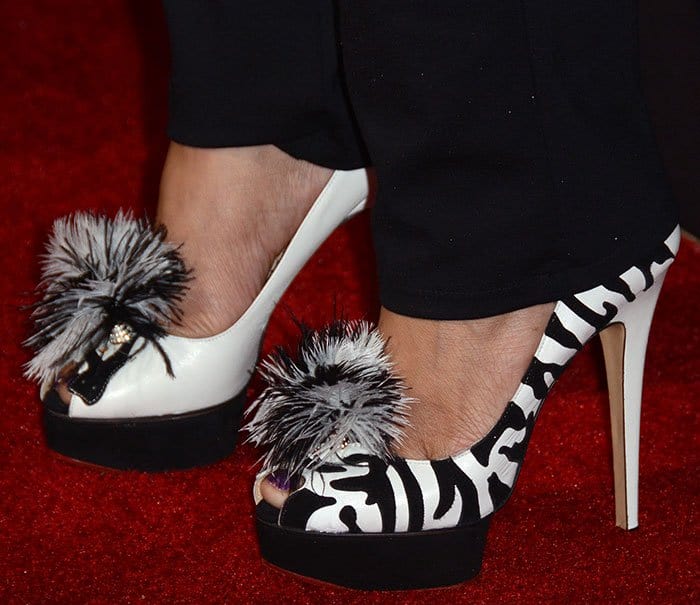 Dascha Polanco completes her red carpet ensemble with bold zebra-striped Charlotte Olympia platform pumps featuring eye-catching feather embellishments and rhinestone accents