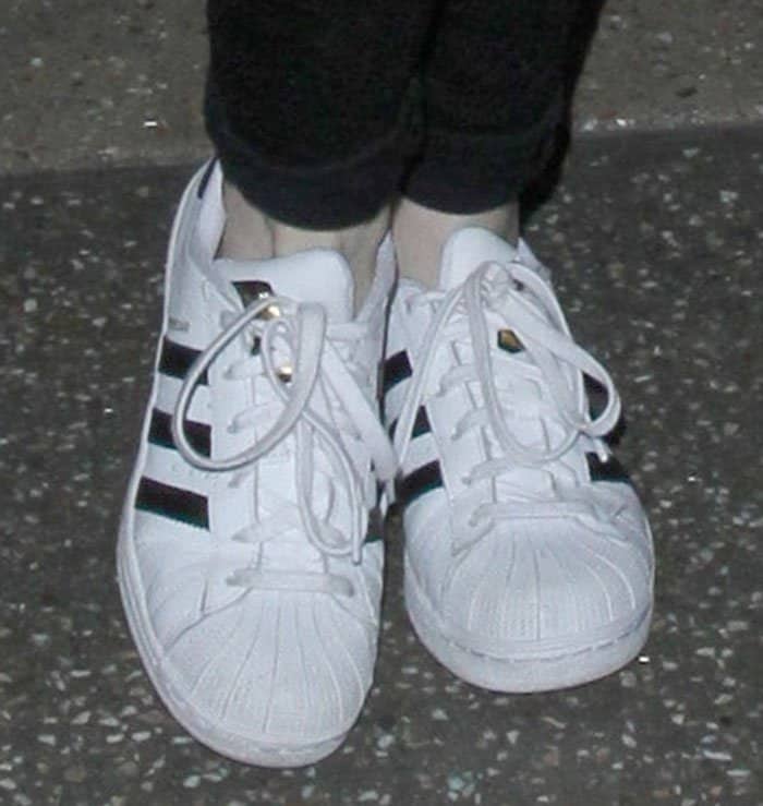 Adidas 'Superstar' sneakers have gained popularity among celebrities for their classic design and versatile appeal, making them a go-to choice for stylish yet comfortable travel footwear