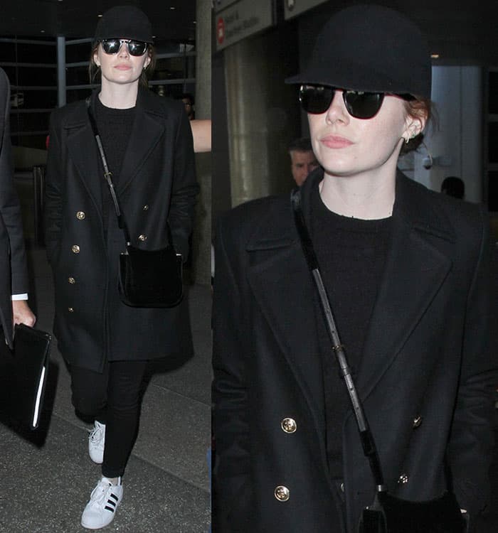 Emma Stone kept it chic and casual at LAX on December 19, 2016, in a Frame nautical peacoat, The Row velvet hunting bag, Ray-Ban RB4258 sunglasses, and Adidas Originals sneakers
