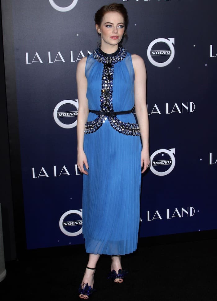 Pair a pleated embellished dress with a cinched waist belt and statement heels for a sophisticated red carpet look that balances elegance with modern glamour