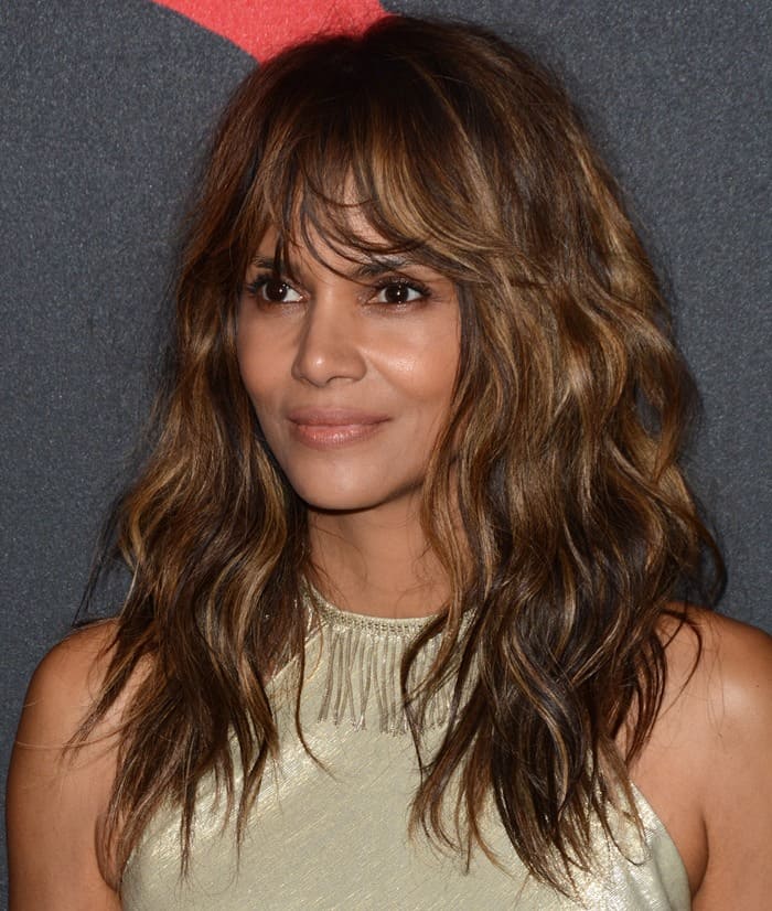 Halle Berry exudes effortless glamour with tousled waves and a soft, radiant makeup look