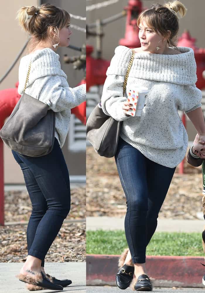 Hilary Duff keeps it casual yet chic in a cozy off-shoulder sweater, dark skinny jeans, and fur-lined Gucci Princetown mules while out in Los Angeles