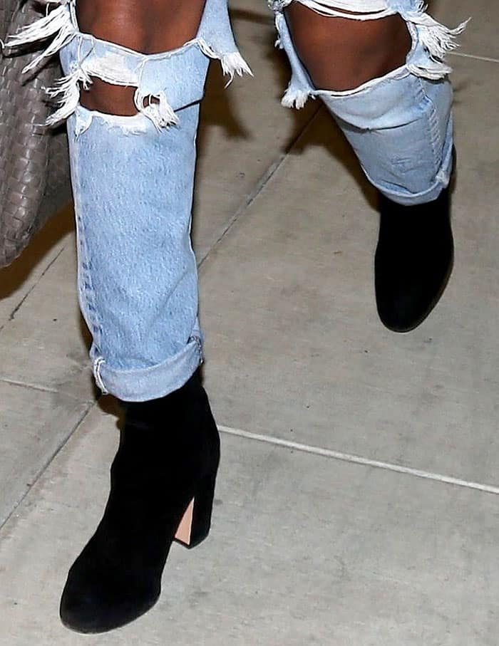 Kelly Rowland adds a rugged edge to her look with light-wash ripped jeans
