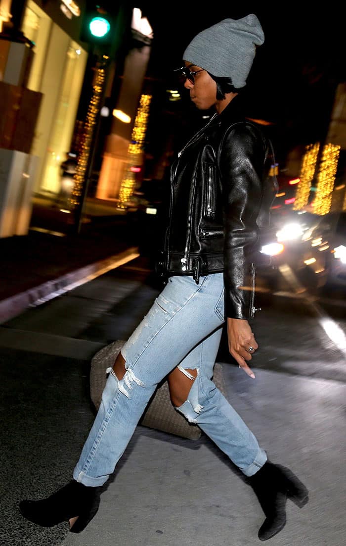 Kelly Rowland struts through Beverly Hills in a bold ensemble, pairing her leather biker jacket with ripped jeans, a cozy beanie, and black suede boots