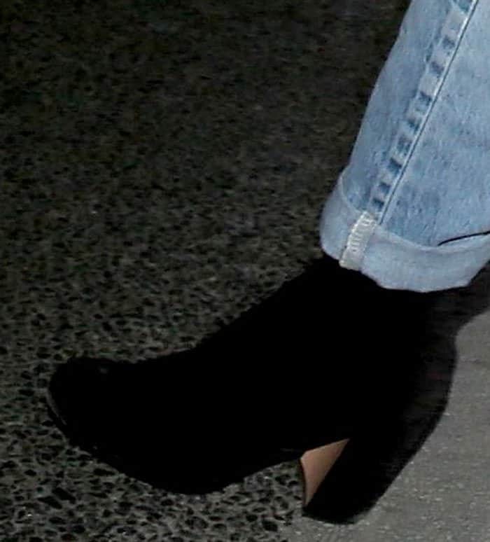 Kelly Rowland steps up her style game with sleek black suede ankle boots featuring a curved heel