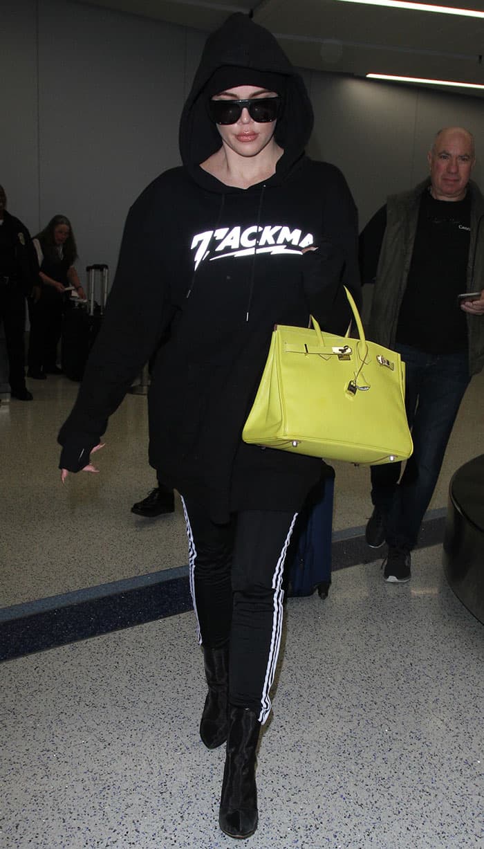 Khloé Kardashian wears black Adidas Supergirl track pants