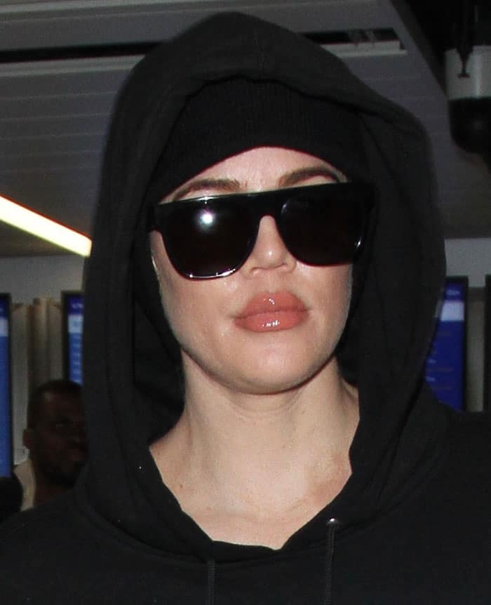 Khloé Kardashian wears Saint Laurent Sl1 sunglasses and a Tackma the Calm Hood hoodie