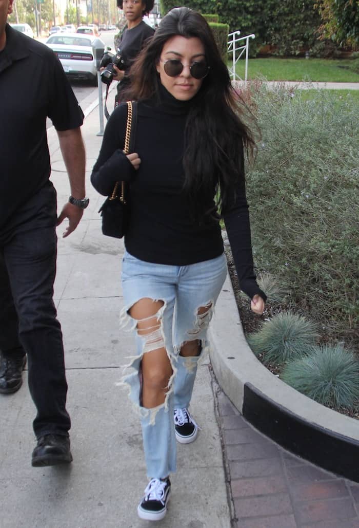 Kourtney Kardashian wears Good American Good Cuts jeans with a classic Wolford pullover
