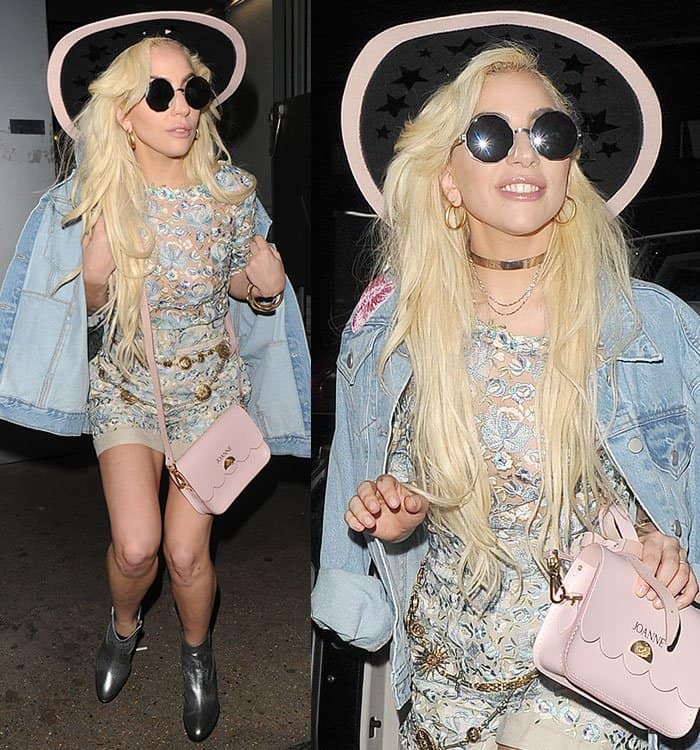 Lady Gaga tops off her look with a wide-brimmed star-embellished hat, a pink scalloped Joanne handbag, and flowing blonde waves for a chic night out