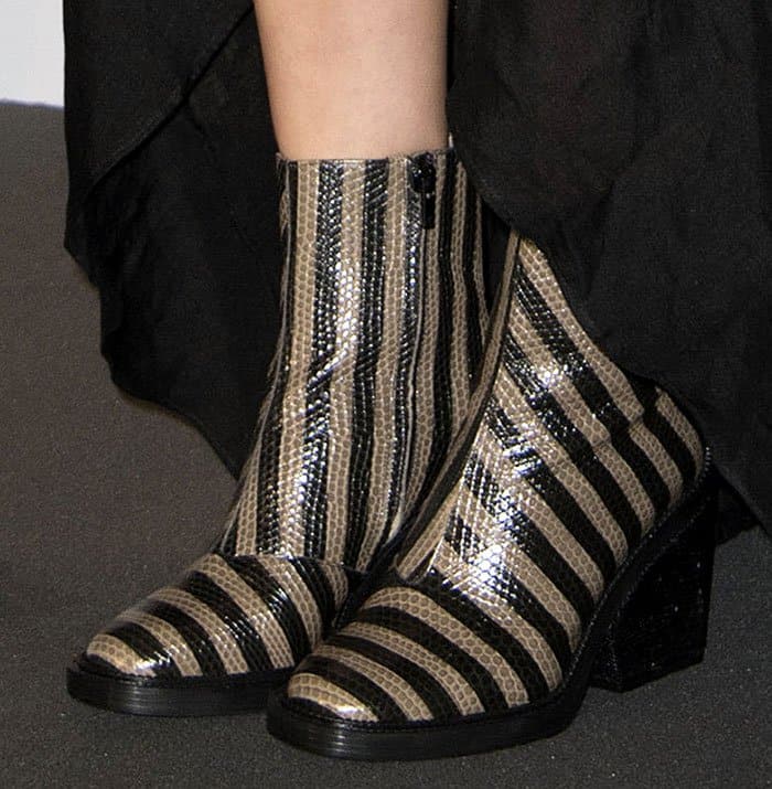 Marion Cotillard elevates her edgy ensemble with eye-catching Robert Clergerie striped lizard-effect boots