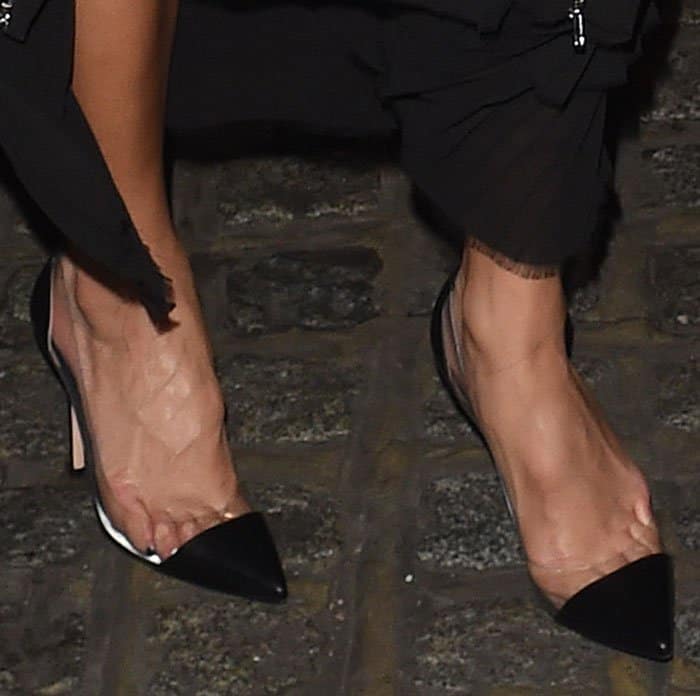 Nicole Scherzinger flaunts her sleek pedicure in black Gianvito Rossi pumps with clear PVC sides and leather pointed toes