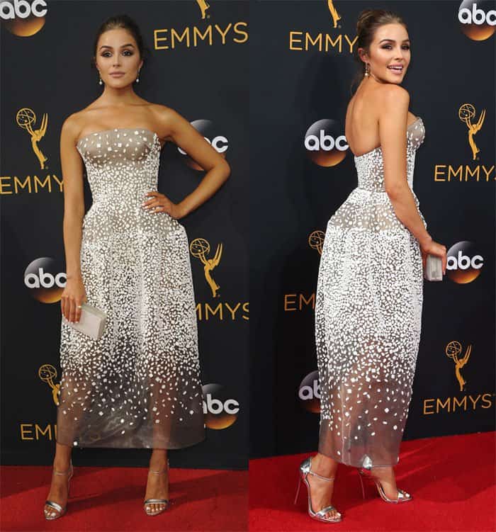 Olivia Culpo dazzles at the Emmys in a chic, strapless tea-length gown adorned with delicate embellishments, perfectly paired with metallic heels for a modern twist