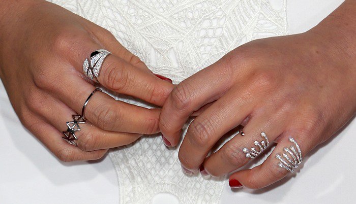 Olivia Munn shows off her chic red manicure and stylish silver rings