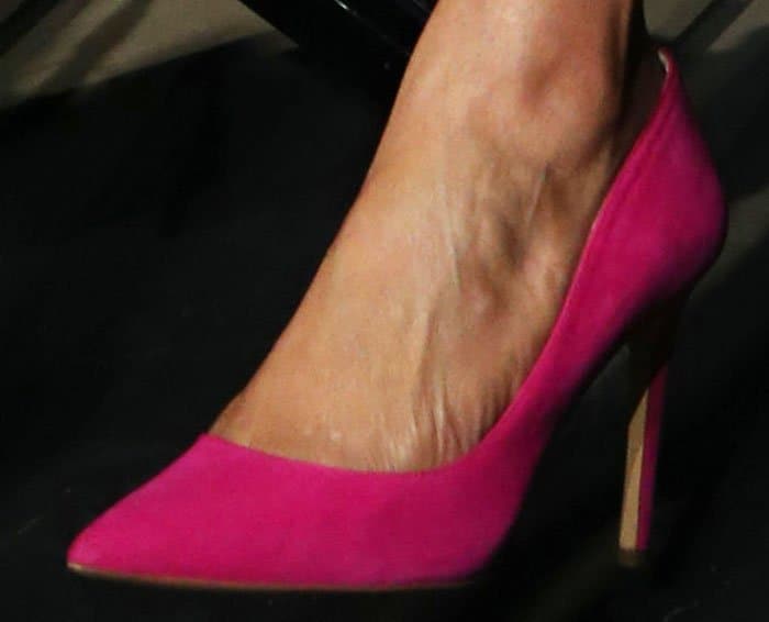 Tyra matches her lipstick to her pink INC International Concepts "Kenjay" d'Orsay pumps