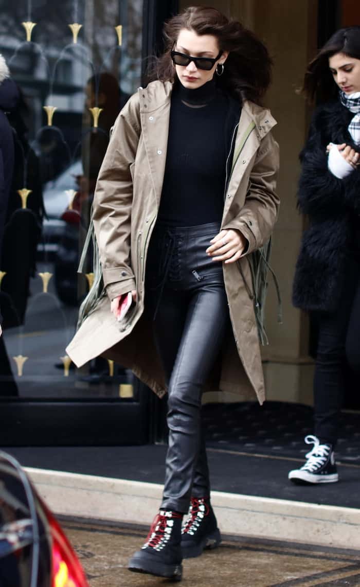 Bella Hadid was spotted shopping at Prada in Paris on January 23, 2017, wearing Celine Eva Cl41339 sunglasses, Off-White suede hiking mountain boots, and carrying a Dior black mirror calfskin Diorama Club bag with a sequin badge