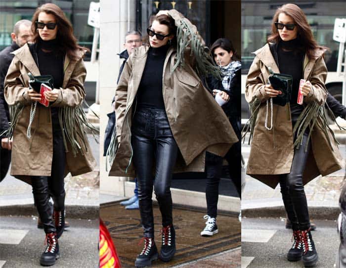Bella Hadid shopping in Paris, styled in an oversized fringed trench coat, Celine sunglasses, Off-White hiking boots, and carrying a Dior Diorama Club bag