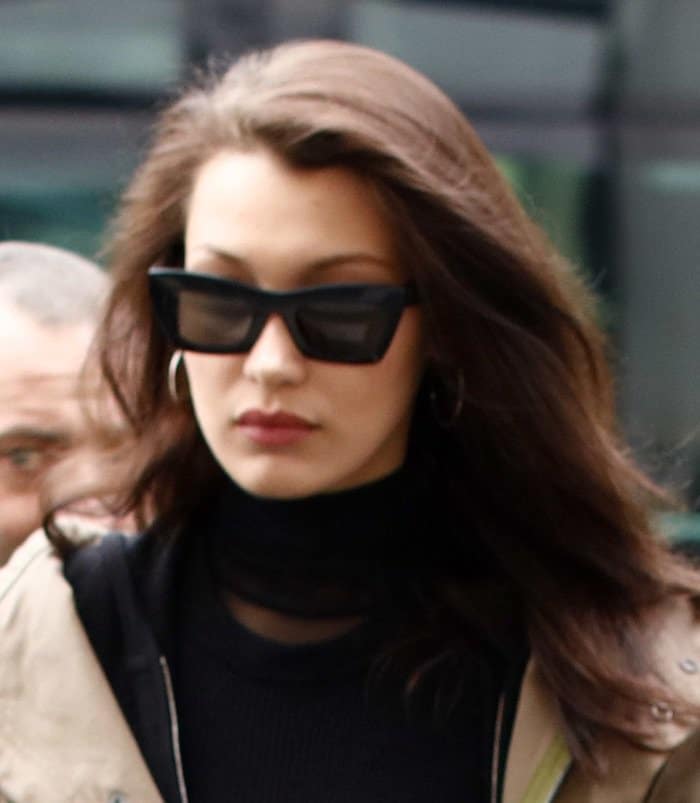 Bella Hadid in Paris with her hair styled down and light makeup, complemented by oversized Celine sunglasses