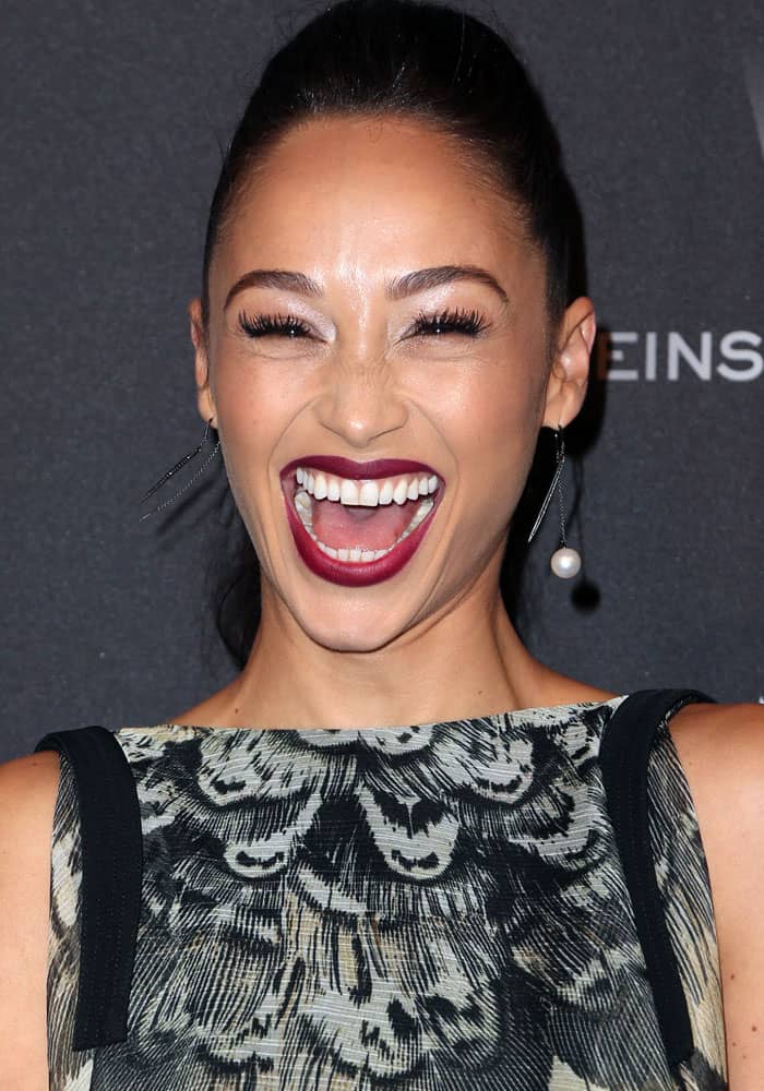 Cara Santana beams with a bold dark lipstick and striking asymmetrical earrings at the 2017 Weinstein Company and Netflix Golden Globes party